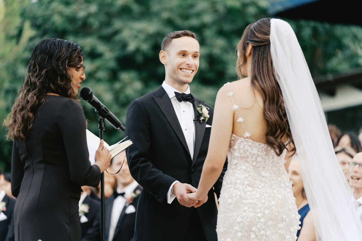 groom looking at the bride